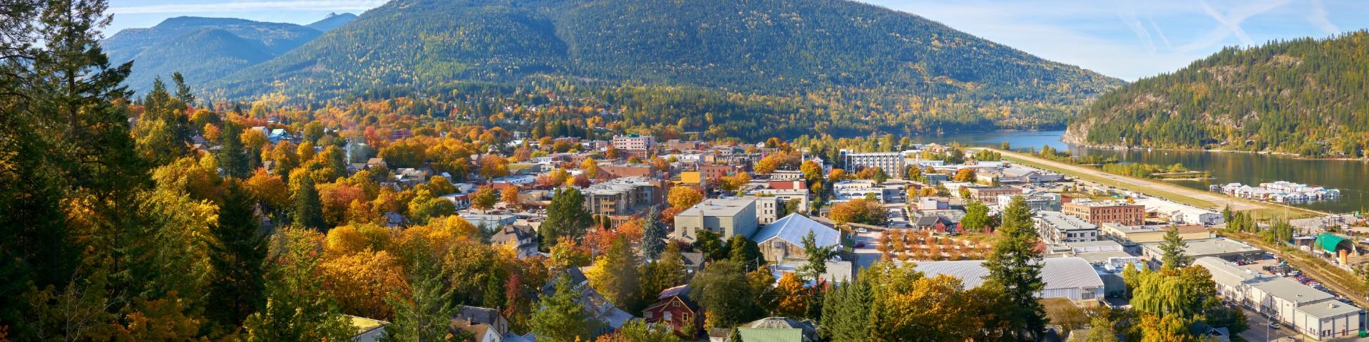 Small town with autumn leaves and mountains